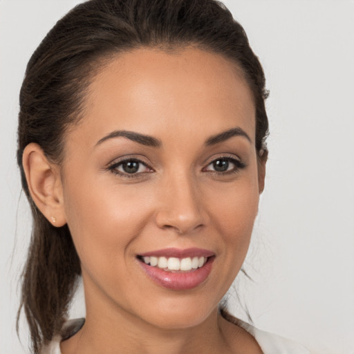 Joyful white young-adult female with medium  brown hair and brown eyes