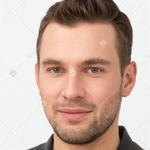 Joyful white young-adult male with short  brown hair and brown eyes