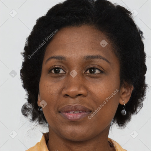Joyful black adult female with medium  brown hair and brown eyes
