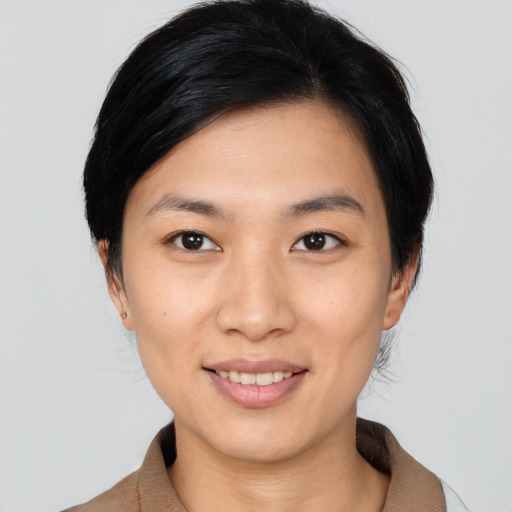 Joyful asian young-adult female with medium  black hair and brown eyes