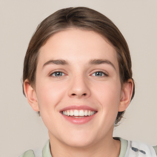 Joyful white young-adult female with medium  brown hair and green eyes