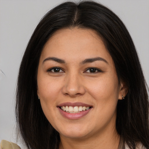 Joyful asian young-adult female with long  brown hair and brown eyes