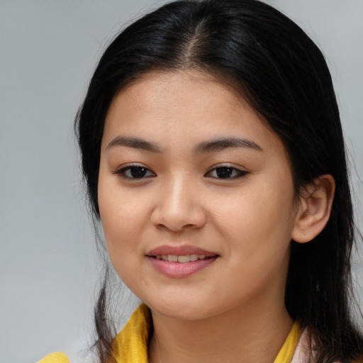 Joyful asian young-adult female with long  brown hair and brown eyes