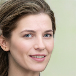 Joyful white young-adult female with long  brown hair and green eyes