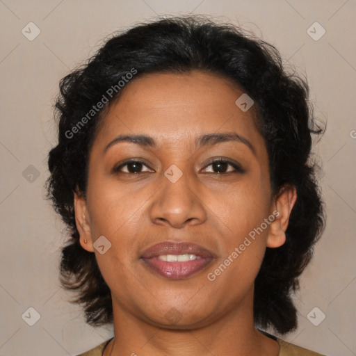 Joyful black adult female with medium  brown hair and brown eyes