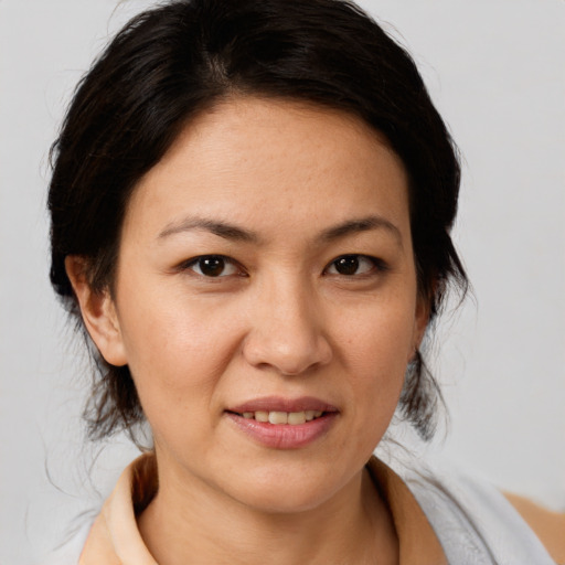 Joyful white adult female with medium  brown hair and brown eyes