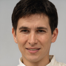 Joyful white adult male with short  brown hair and brown eyes