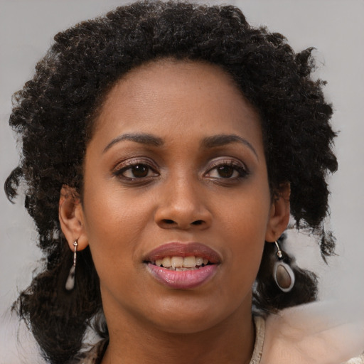 Joyful black young-adult female with medium  brown hair and brown eyes