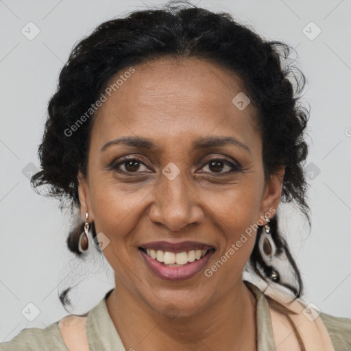 Joyful black adult female with long  brown hair and brown eyes