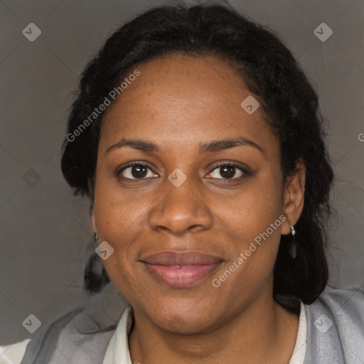 Joyful black adult female with medium  brown hair and brown eyes