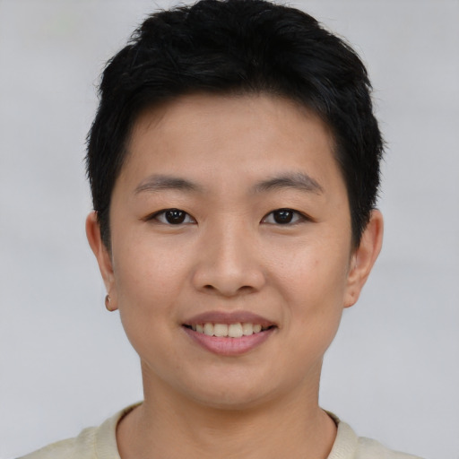 Joyful asian young-adult male with short  brown hair and brown eyes