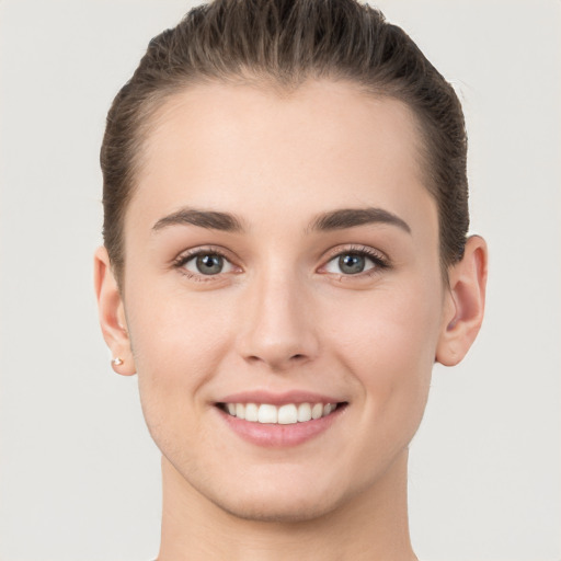 Joyful white young-adult female with short  brown hair and brown eyes