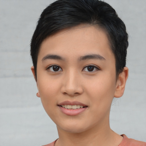 Joyful asian young-adult female with short  black hair and brown eyes