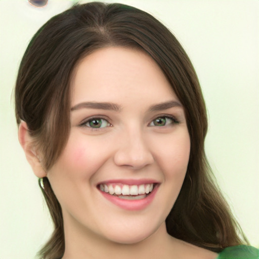 Joyful white young-adult female with medium  brown hair and green eyes