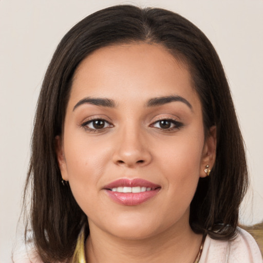 Joyful white young-adult female with long  brown hair and brown eyes