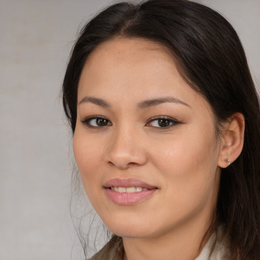 Joyful asian young-adult female with medium  brown hair and brown eyes