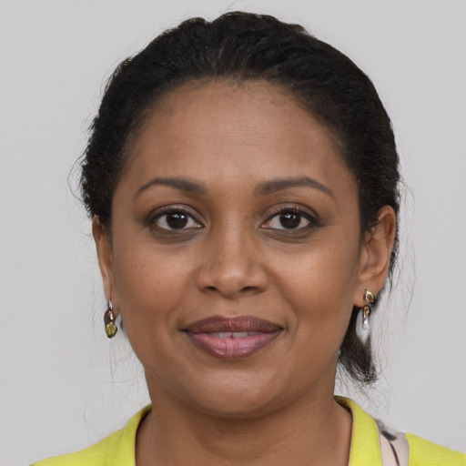 Joyful black young-adult female with medium  brown hair and brown eyes