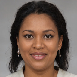 Joyful black adult female with medium  brown hair and brown eyes