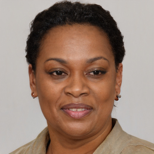 Joyful black adult female with short  brown hair and brown eyes