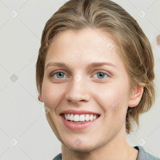 Joyful white young-adult female with medium  brown hair and green eyes