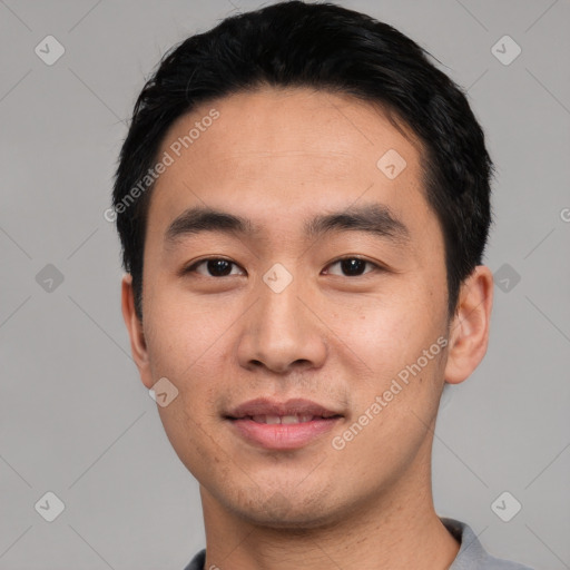 Joyful asian young-adult male with short  black hair and brown eyes