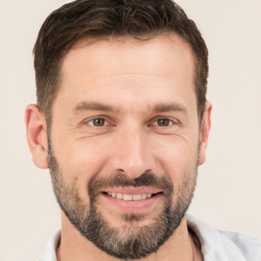 Joyful white young-adult male with short  brown hair and brown eyes