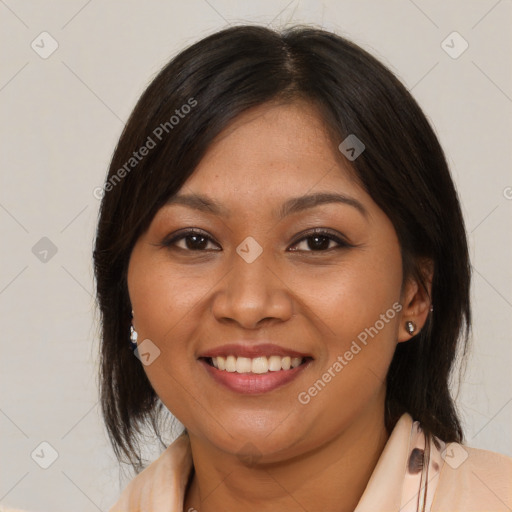 Joyful latino young-adult female with medium  brown hair and brown eyes