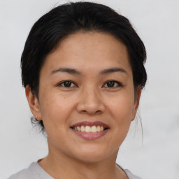 Joyful asian young-adult female with short  black hair and brown eyes