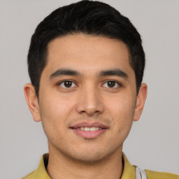 Joyful latino young-adult male with short  brown hair and brown eyes