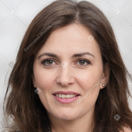 Joyful white adult female with long  brown hair and brown eyes