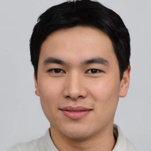 Joyful asian young-adult male with short  black hair and brown eyes