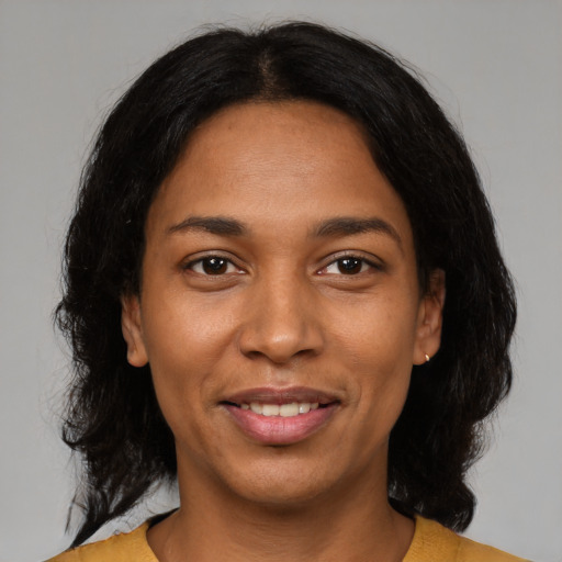 Joyful black young-adult female with medium  black hair and brown eyes