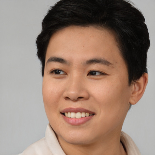 Joyful asian young-adult female with short  brown hair and brown eyes