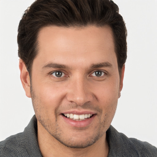 Joyful white young-adult male with short  brown hair and brown eyes