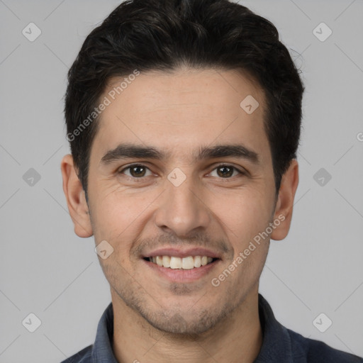 Joyful white young-adult male with short  black hair and brown eyes