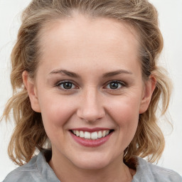 Joyful white young-adult female with medium  brown hair and blue eyes