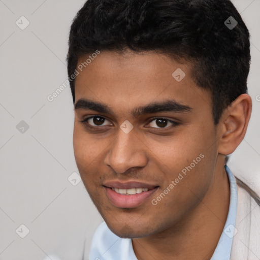 Joyful latino young-adult male with short  black hair and brown eyes