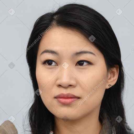 Joyful asian young-adult female with long  black hair and brown eyes