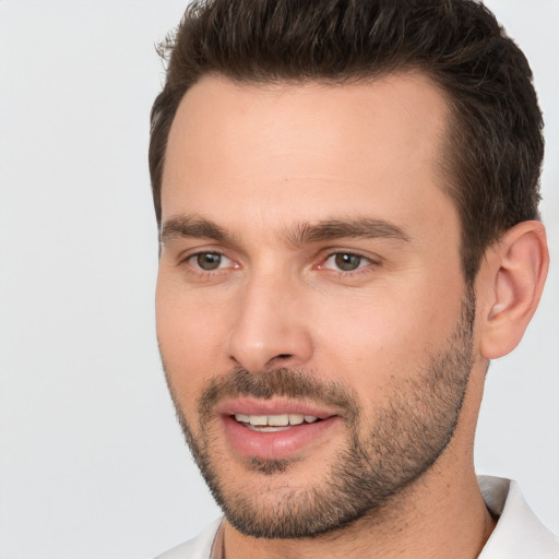 Joyful white young-adult male with short  brown hair and brown eyes