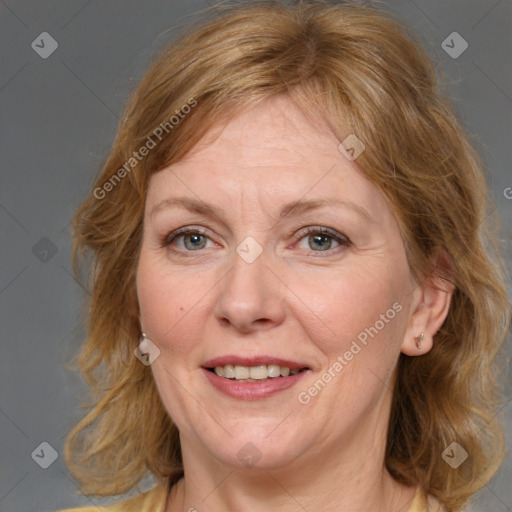 Joyful white adult female with medium  brown hair and grey eyes