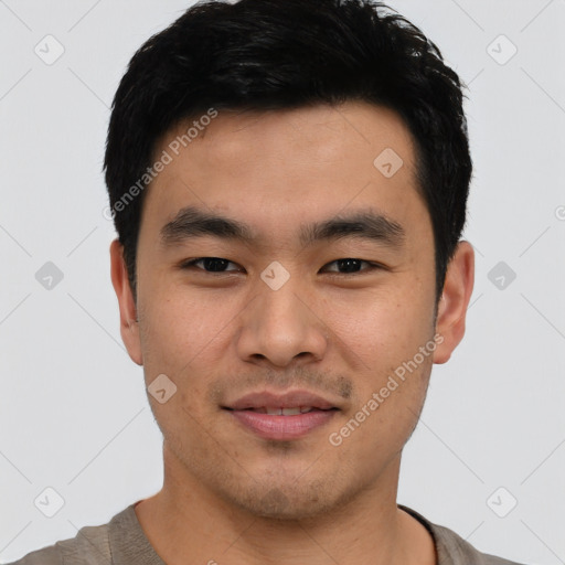 Joyful asian young-adult male with short  black hair and brown eyes