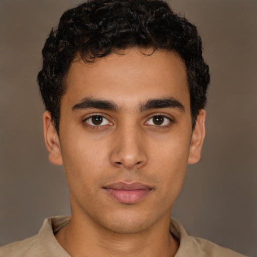 Joyful latino young-adult male with short  brown hair and brown eyes