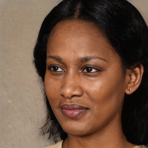 Joyful black young-adult female with medium  black hair and brown eyes