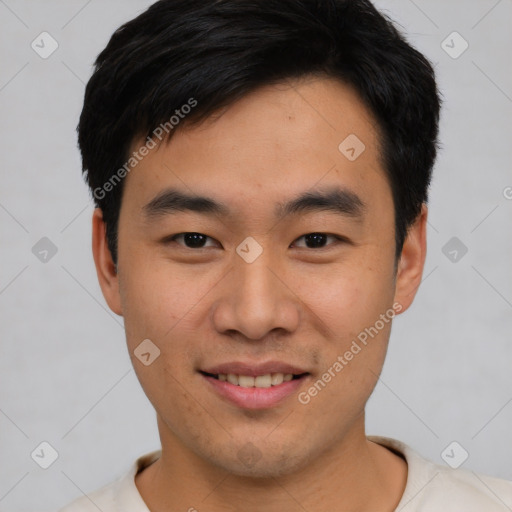 Joyful asian young-adult male with short  black hair and brown eyes