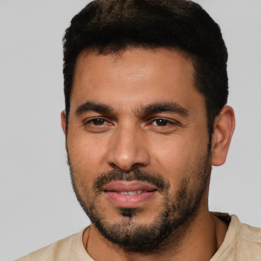Joyful white young-adult male with short  black hair and brown eyes