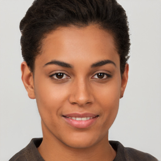 Joyful latino young-adult female with short  brown hair and brown eyes