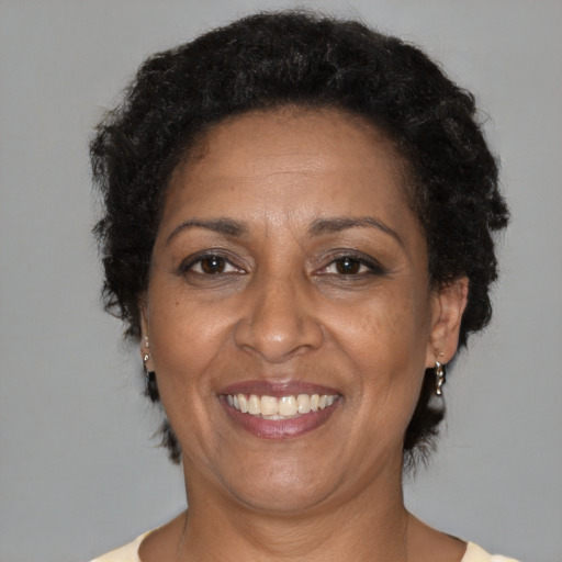 Joyful black adult female with short  brown hair and brown eyes