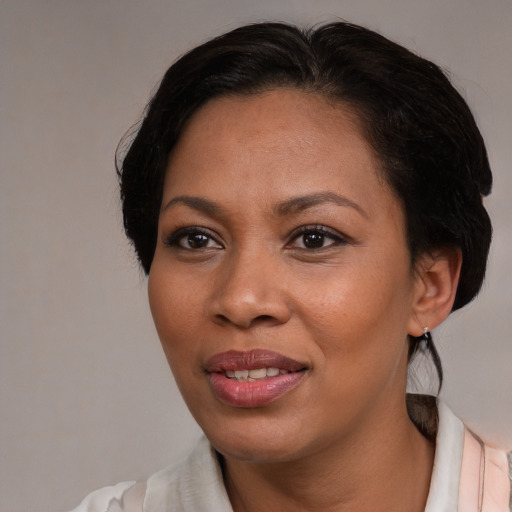 Joyful black adult female with medium  black hair and brown eyes