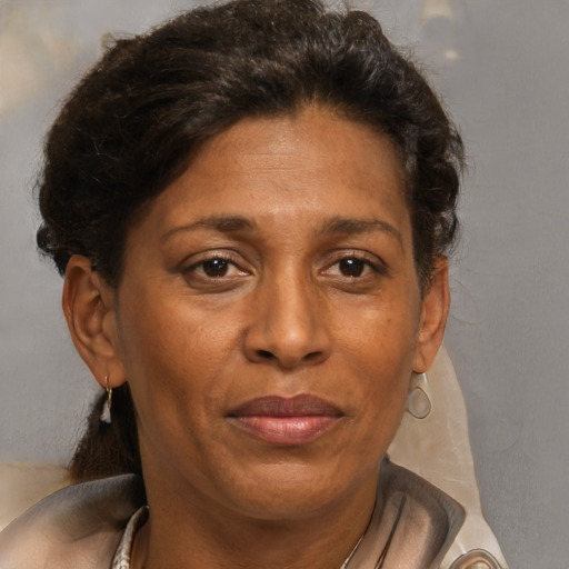 Joyful black adult female with short  brown hair and brown eyes