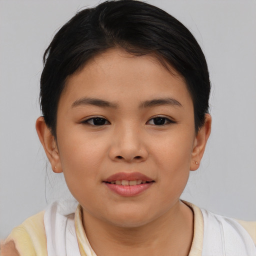 Joyful asian child female with short  brown hair and brown eyes